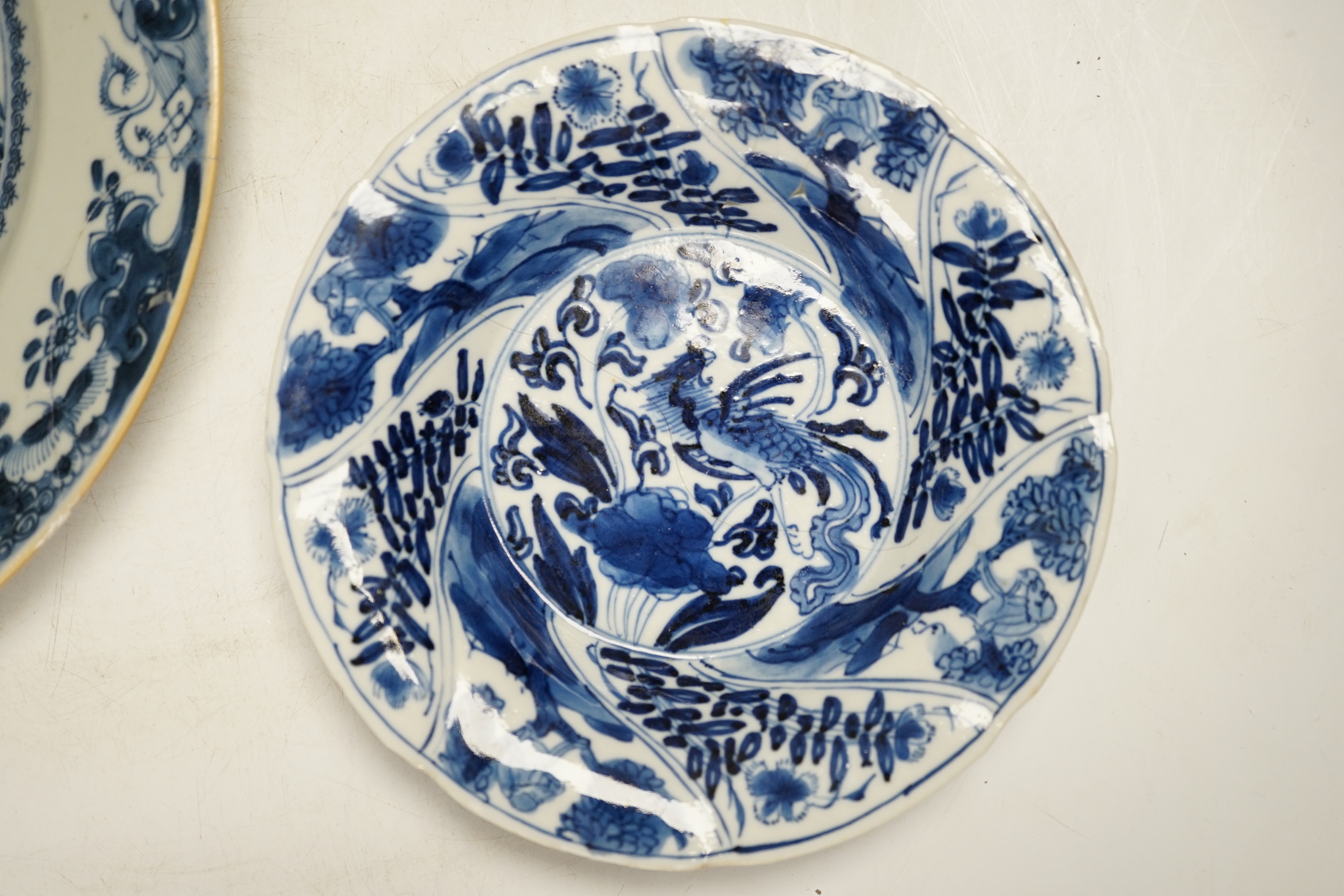 An 18th century Chinese export blue and white dish together with two others, largest 26cm